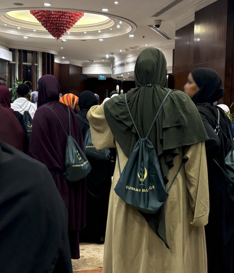 Group gathering in a hotel lobby before setting off, all carrying their Sunnah Balance bags